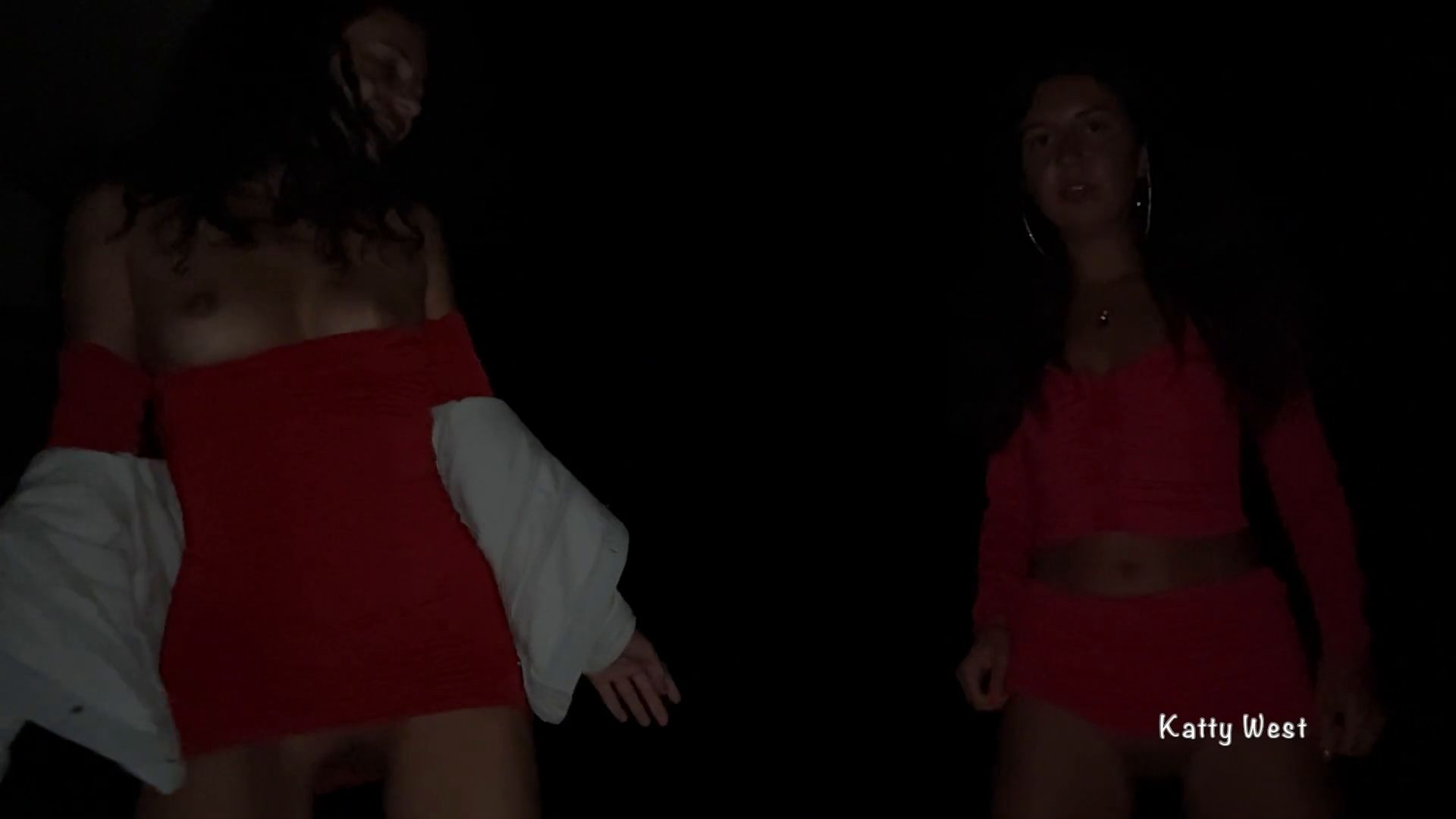 Two girls pissing on a public promenade on the beach