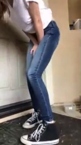 Wetting jeans on her doorstep